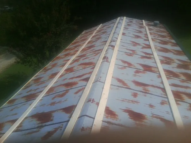 Rusted metal roof panels with new wood purlins before replacement — Storm Damage Roof Repair in Moorpark by Roofing Brothers