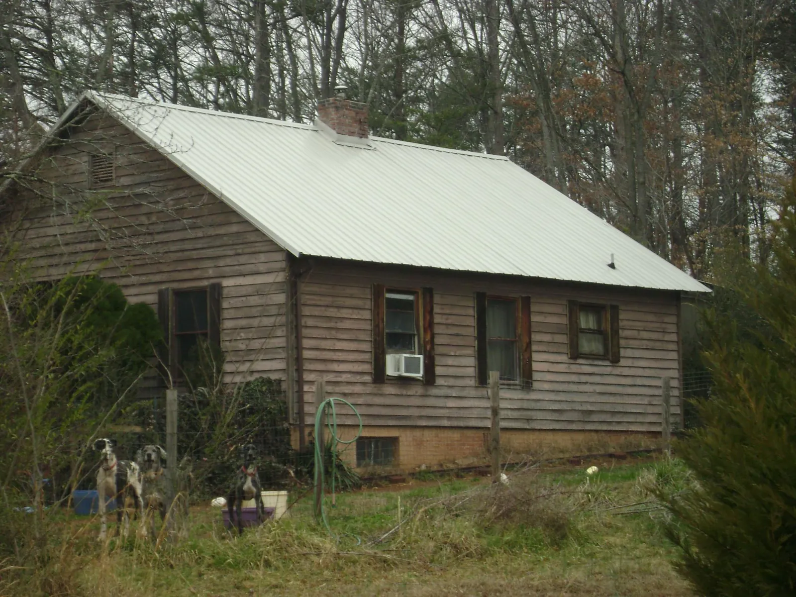 White metal roof on an old wood sided farmhouse, from a Metal Roof Installation job in Moorpark